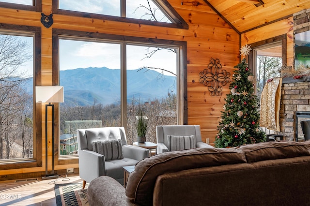 interior space featuring a mountain view, a wealth of natural light, lofted ceiling, and wood ceiling