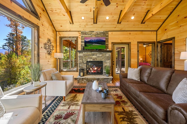 living room with beamed ceiling, wood-type flooring, wood walls, and wood ceiling