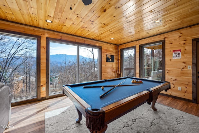 rec room featuring light hardwood / wood-style flooring, a mountain view, plenty of natural light, wood ceiling, and pool table