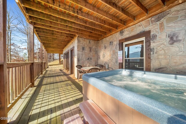 wooden terrace featuring a hot tub