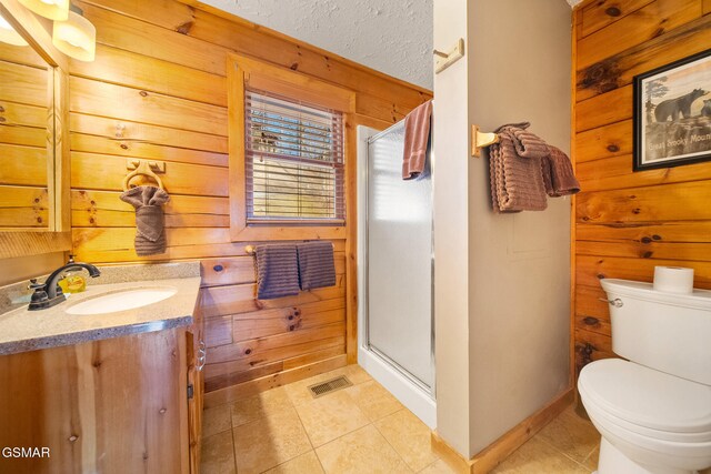 bathroom with wooden walls, an enclosed shower, vanity, tile patterned floors, and toilet