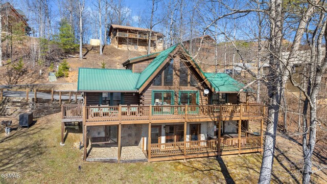 back of property featuring a wooden deck