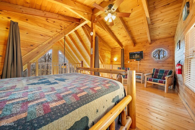 bedroom with wooden walls, lofted ceiling with beams, light hardwood / wood-style floors, and wooden ceiling