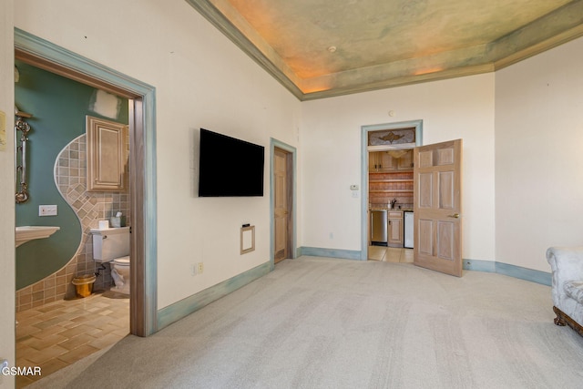 bedroom with light colored carpet and baseboards