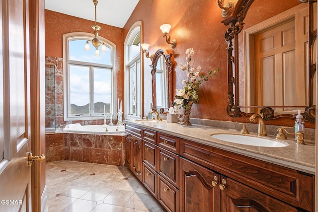 full bath featuring a bath, double vanity, a sink, and tile patterned floors