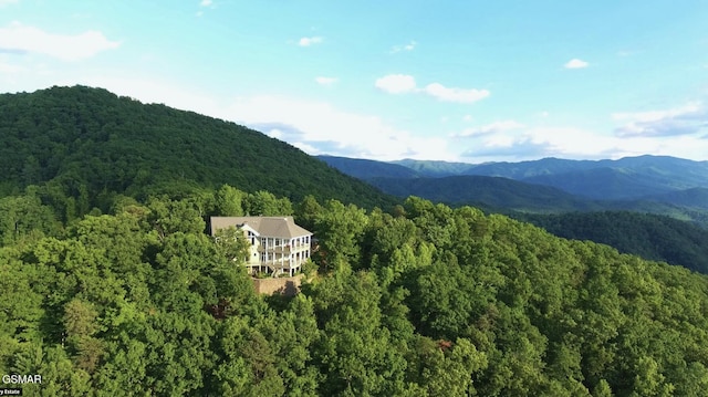 drone / aerial view featuring a mountain view and a wooded view