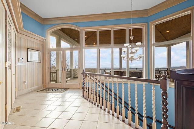 sunroom / solarium featuring a healthy amount of sunlight, visible vents, and an inviting chandelier