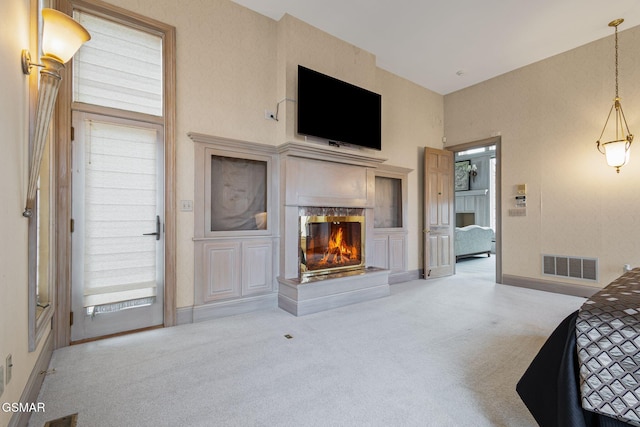 bedroom with carpet floors, baseboards, visible vents, and a multi sided fireplace