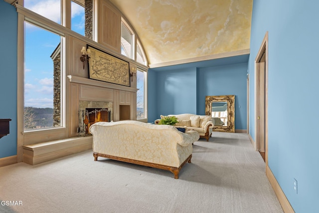 sitting room with carpet, a high end fireplace, and a wealth of natural light