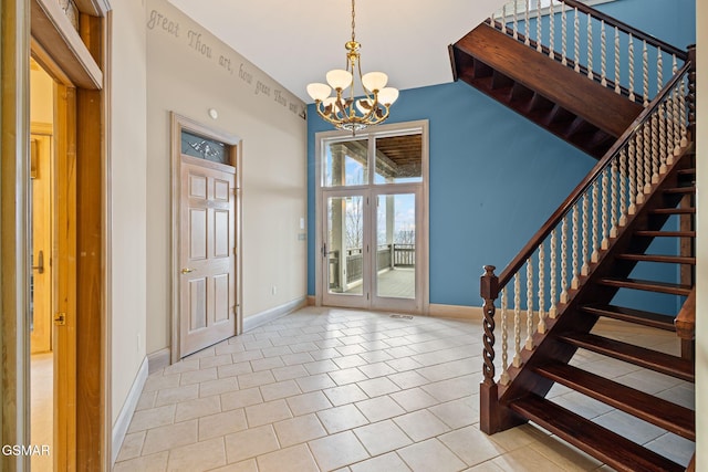 foyer entrance with a chandelier, french doors, baseboards, and stairs