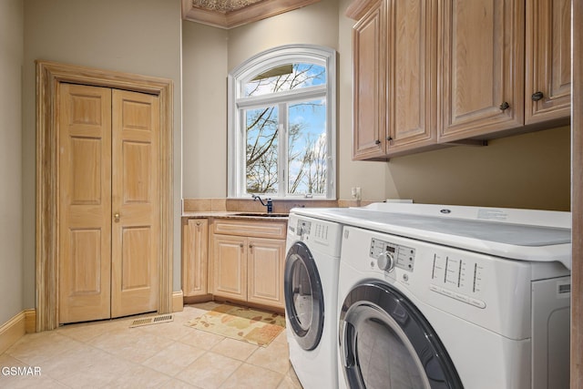 washroom with cabinet space, light tile patterned floors, visible vents, independent washer and dryer, and a sink