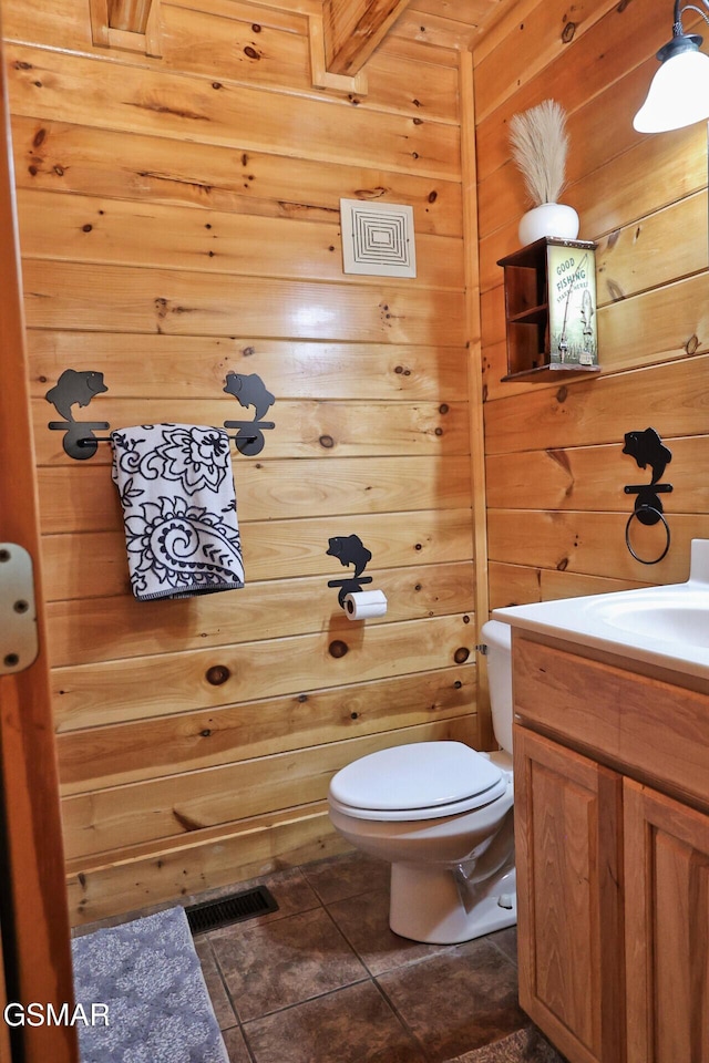 1946 Cougar Crossing Way Bear Country Retreat, Bear Country Retreat, Sevierville, TN 37862 - bathroom with visible vents, toilet, wood walls, vanity, and tile patterned floors