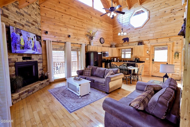 1946 Cougar Crossing Way Bear Country Retreat, Bear Country Retreat, Sevierville, TN 37862 - living area with wooden walls, a fireplace, a ceiling fan, and light wood-style floors