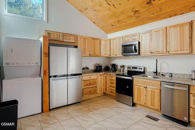 3149 Mutton Hollow Rd, Kodak, TN 37764 - kitchen with stainless steel appliances, estacked washer and dryer, light marble finish floors, lofted ceiling, and wood ceiling