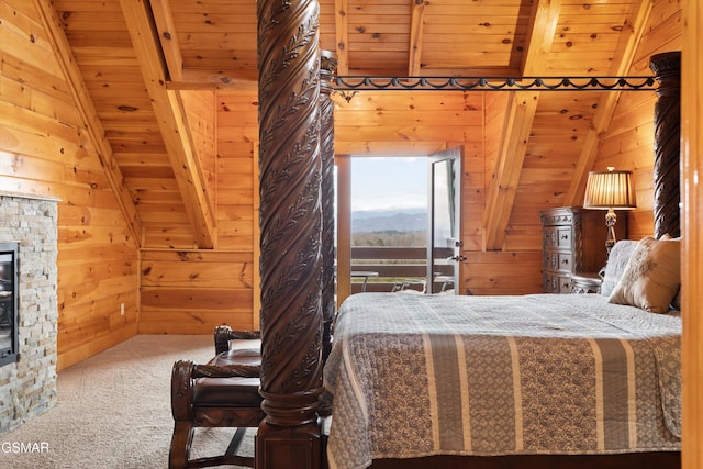 bedroom featuring a stone fireplace, wooden walls, lofted ceiling with beams, carpet flooring, and wooden ceiling