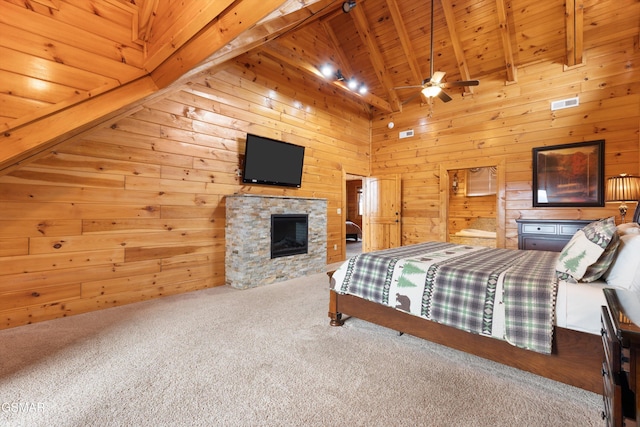 carpeted bedroom featuring beam ceiling, high vaulted ceiling, wooden ceiling, wooden walls, and a fireplace