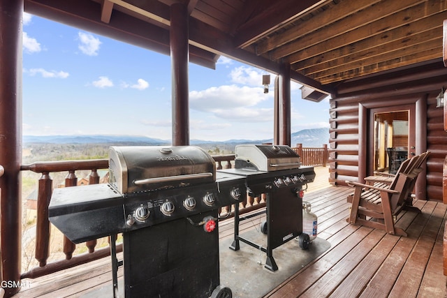 wooden terrace with a mountain view and a grill