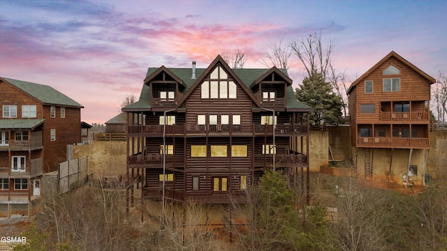 view of back house at dusk