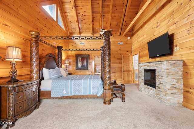 bedroom with wood ceiling, carpet, a stone fireplace, beamed ceiling, and wood walls