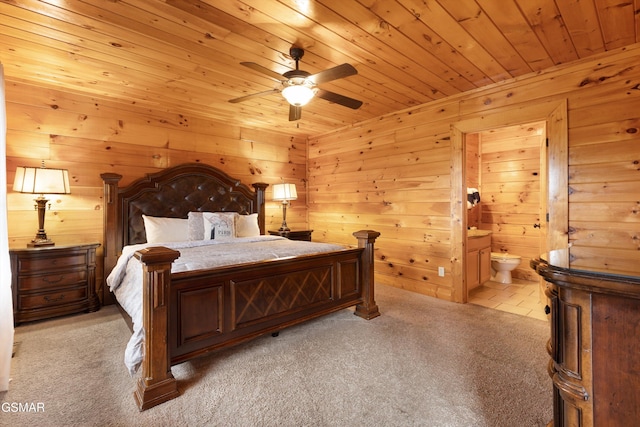 carpeted bedroom featuring connected bathroom, wood ceiling, and ceiling fan