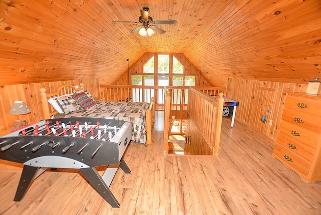 bedroom featuring wooden walls, light hardwood / wood-style flooring, wooden ceiling, and vaulted ceiling