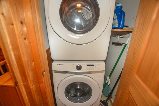 washroom featuring stacked washer / dryer