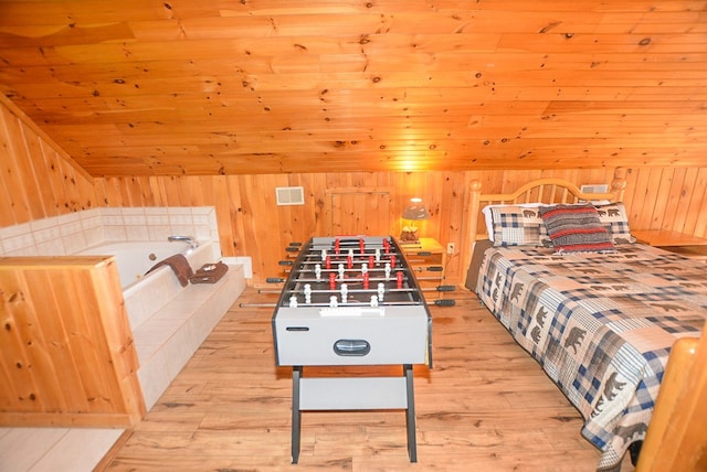 bedroom with wood ceiling, light hardwood / wood-style flooring, and vaulted ceiling