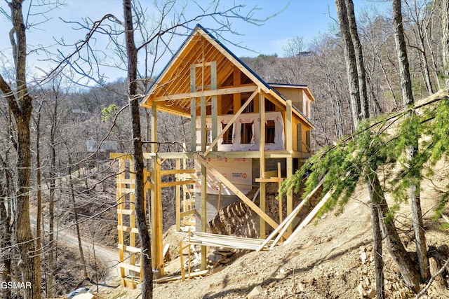 view of outbuilding with a forest view