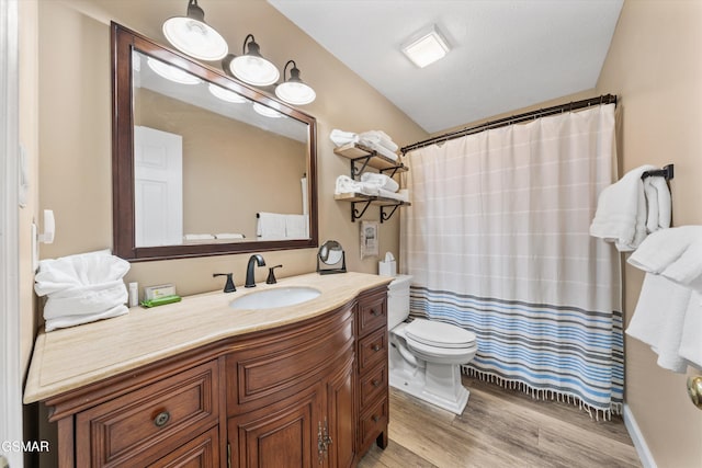 full bath featuring a shower with shower curtain, toilet, vanity, and wood finished floors