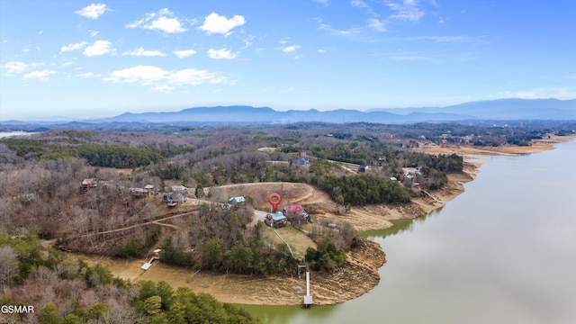 aerial view with a forest view and a water and mountain view