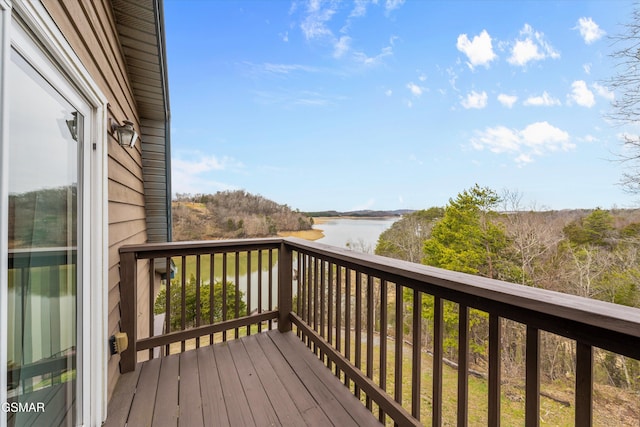 wooden terrace featuring a water view