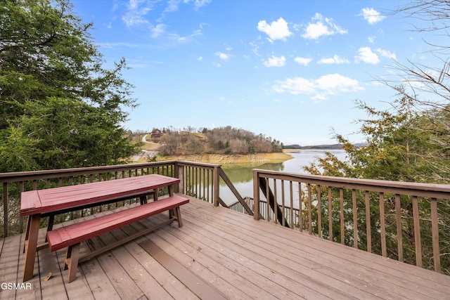 wooden terrace featuring a water view