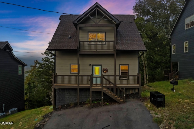 2125 Eagle Feather Dr, Sevierville, TN 37876 - view of front of property with a balcony, a shingled roof, central AC unit, and stairs