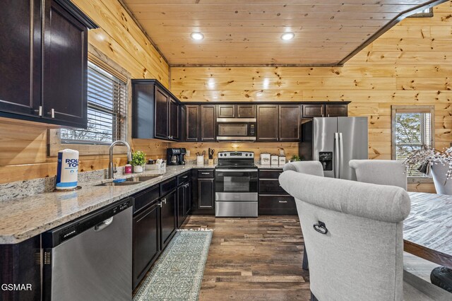 2125 Eagle Feather Dr, Sevierville, TN 37876 - kitchen featuring appliances with stainless steel finishes, a sink, dark wood-style flooring, wooden walls, and wooden ceiling