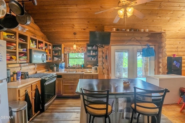 731 Pleasant Grove Rd, Winfield, TN 37892 - kitchen with range with gas stovetop, black microwave, rustic walls, wood ceiling, and a sink