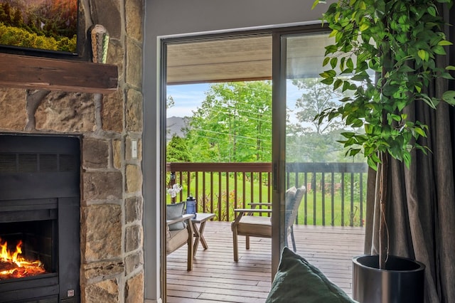 doorway to outside with a fireplace and wood-type flooring