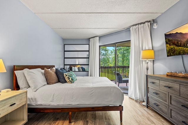 bedroom featuring access to outside and light hardwood / wood-style flooring