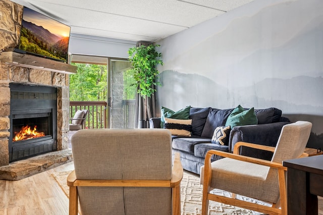 living room with a fireplace, hardwood / wood-style floors, and a textured ceiling