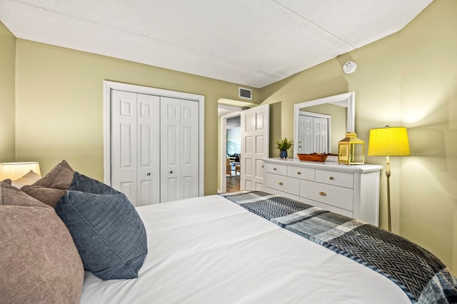 bedroom with a textured ceiling and a closet