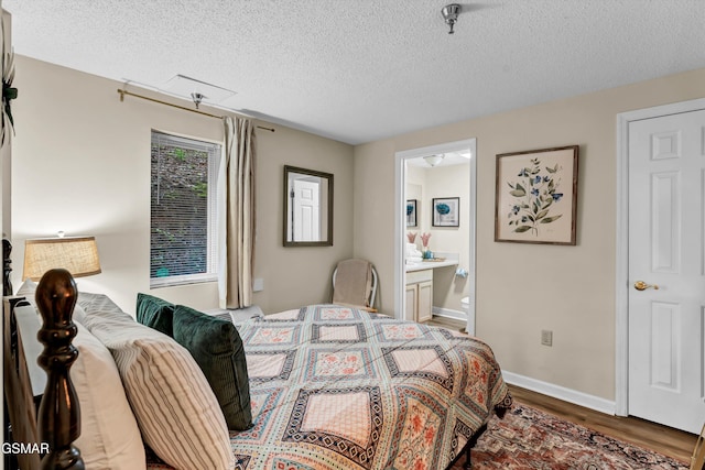 413 Baskins Creek Rd Unit 205, Gatlinburg, TN 37738 - bedroom featuring a textured ceiling, wood finished floors, ensuite bathroom, and baseboards