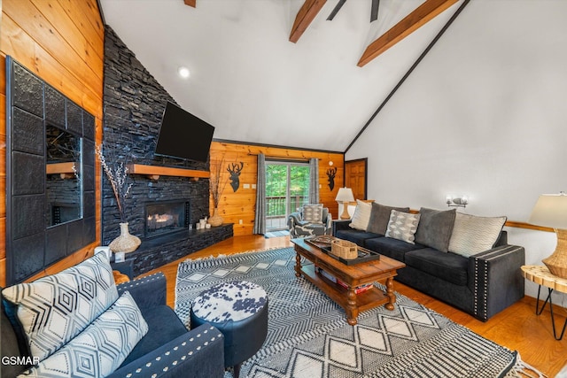 380 Laurel Rd, Townsend, TN 37882 - living room featuring wood finished floors, a stone fireplace, wood walls, beam ceiling, and high vaulted ceiling