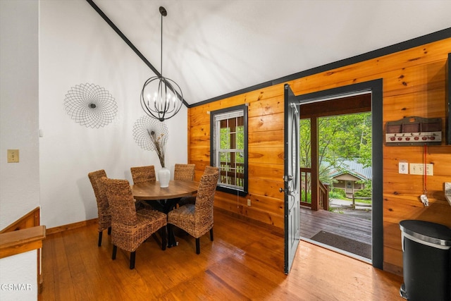 380 Laurel Rd, Townsend, TN 37882 - dining room featuring wood walls, wood finished floors, a chandelier, and baseboards