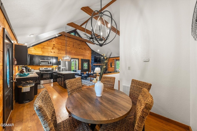 380 Laurel Rd, Townsend, TN 37882 - dining space featuring wooden walls, light wood-style floors, a chandelier, and baseboards