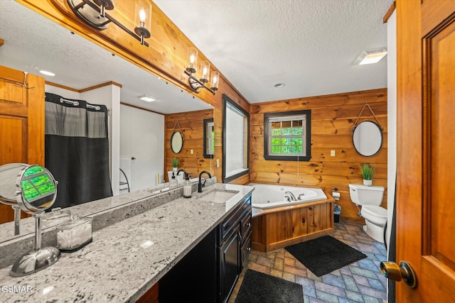 380 Laurel Rd, Townsend, TN 37882 - bathroom featuring a textured ceiling, toilet, wood walls, a jetted tub, and vanity