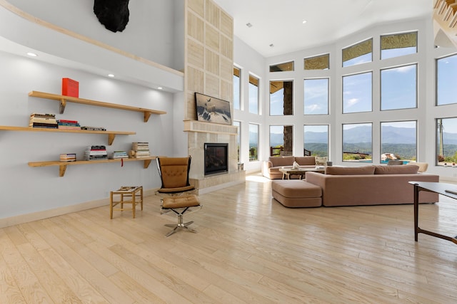 3661 Richardson Cove Rd, Sevierville, TN 37876 - living room with a mountain view, light hardwood / wood-style floors, a fireplace, and a high ceiling