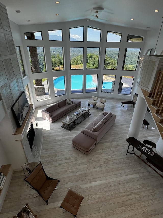 3661 Richardson Cove Rd, Sevierville, TN 37876 - living room with a towering ceiling, light wood-type flooring, ceiling fan, and a premium fireplace