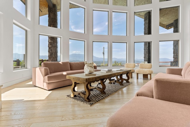 3661 Richardson Cove Rd, Sevierville, TN 37876 - living room featuring a mountain view, a towering ceiling, and light wood-type flooring