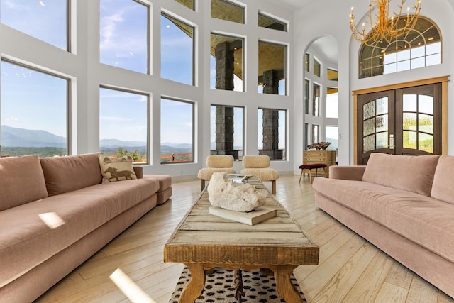 3661 Richardson Cove Rd, Sevierville, TN 37876 - living room with a mountain view, a towering ceiling, a chandelier, and light hardwood / wood-style floors