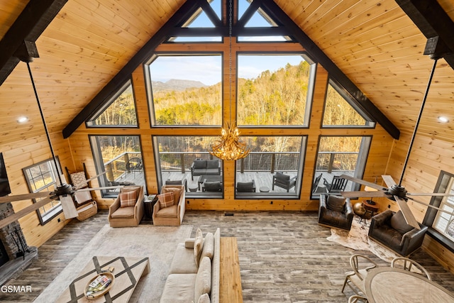 unfurnished living room with plenty of natural light, wooden walls, and wood ceiling