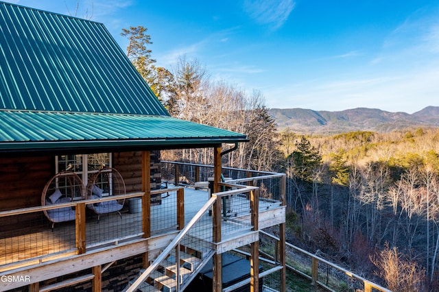 dock area featuring a deck with mountain view and a view of trees